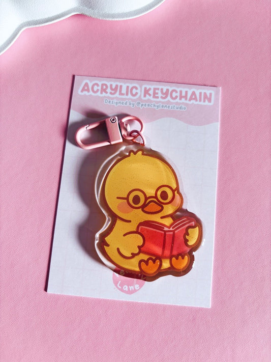 Cosy Reader Duck Glitter Acrylic Keychain