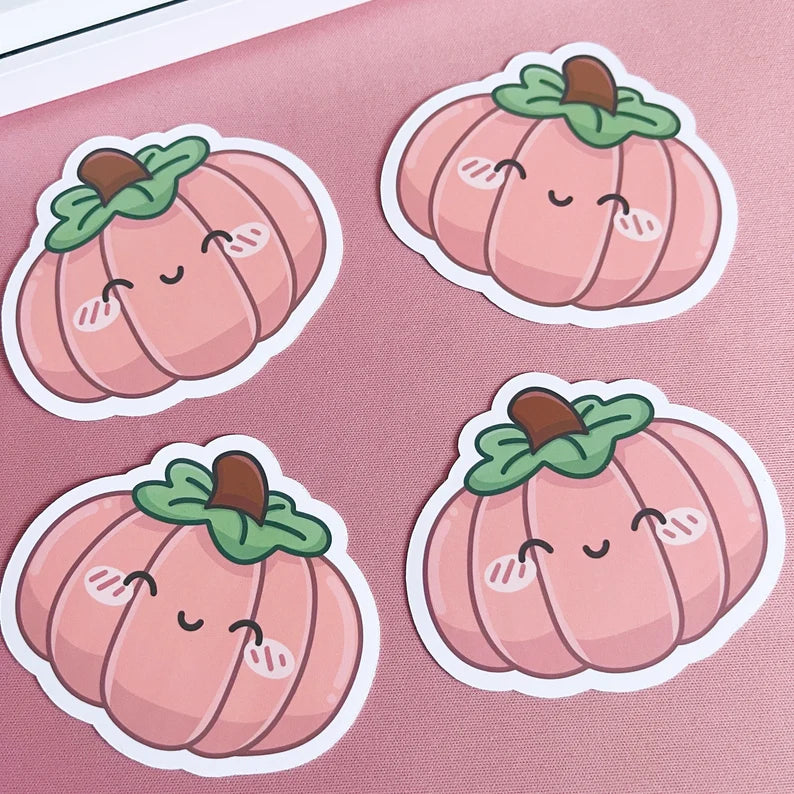 Four cute pink pumpkins with smiling faces on a pink background